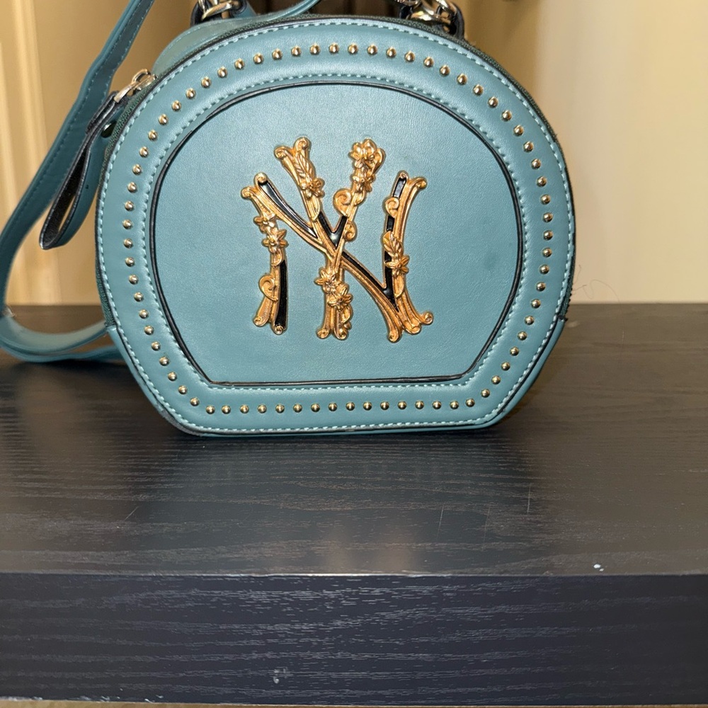 Chic Black Mini Bag with Gold Accents and Sleek Design